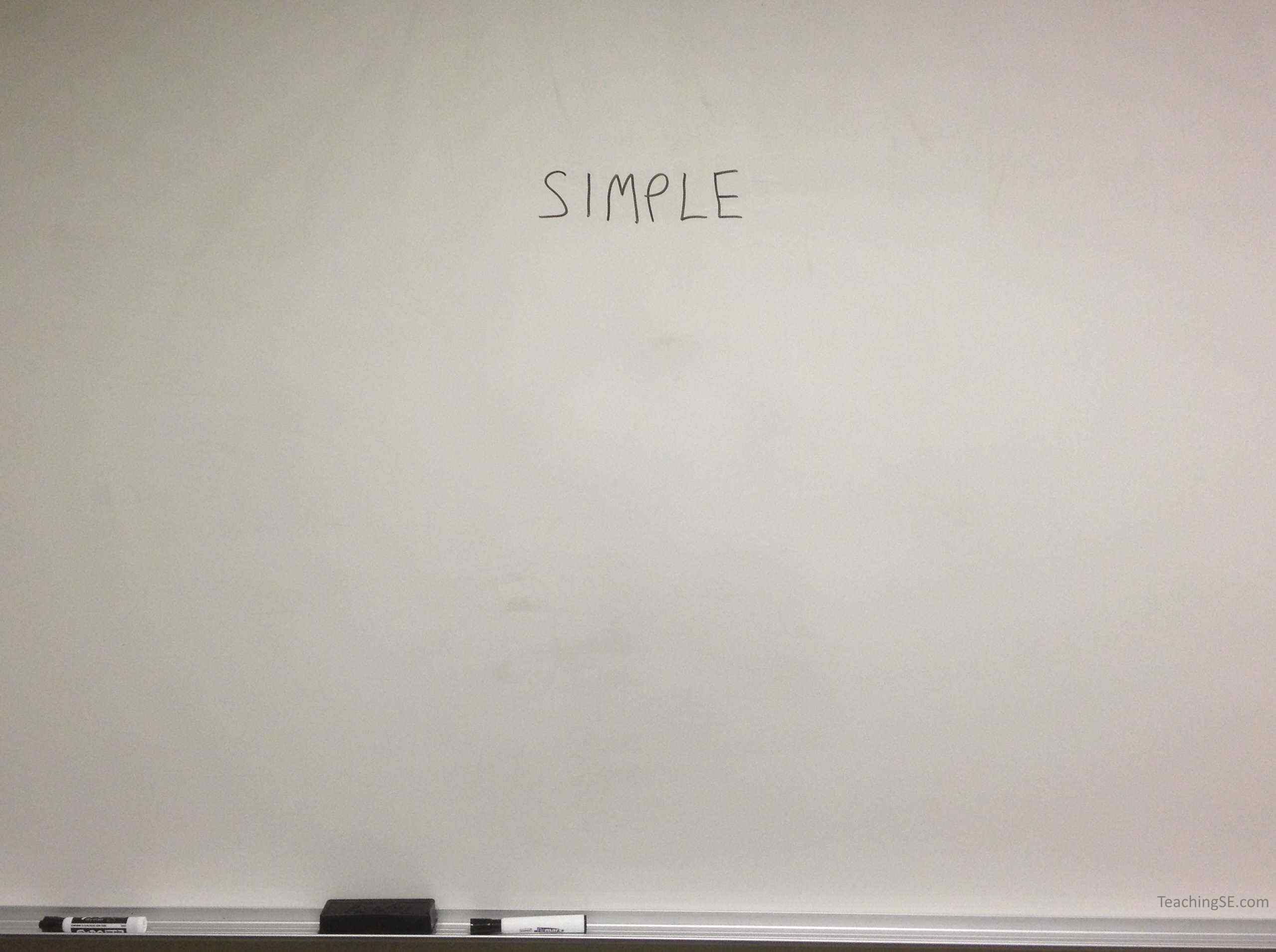 A blank whiteboard with the word 'Simplicity' written on it